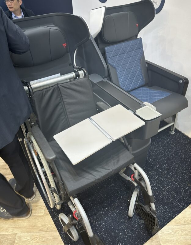 a wheelchairs with a desk and a chair