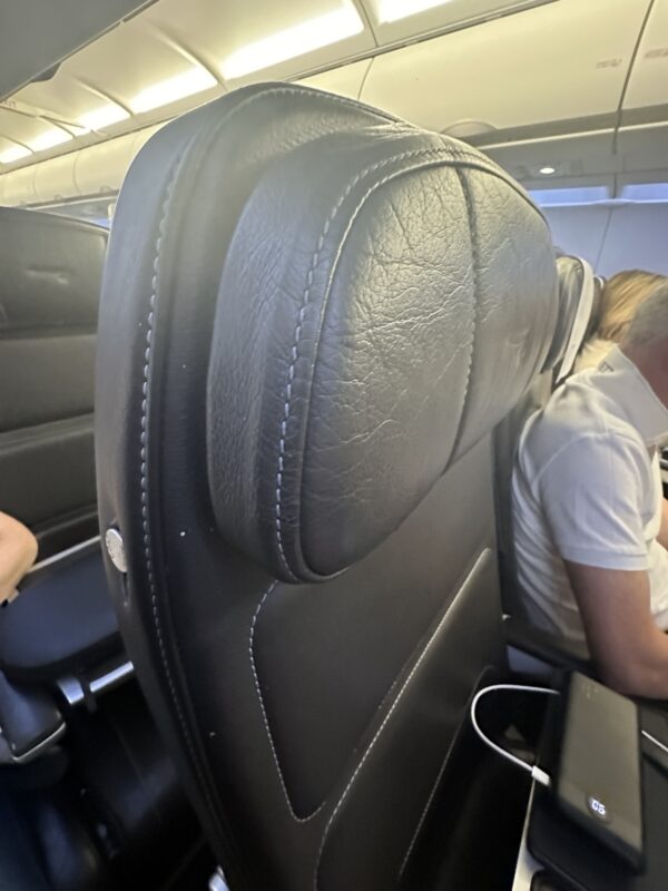 a black leather headrest in an airplane