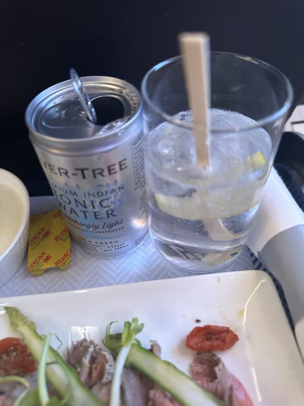 a drink and a can of water on a tray