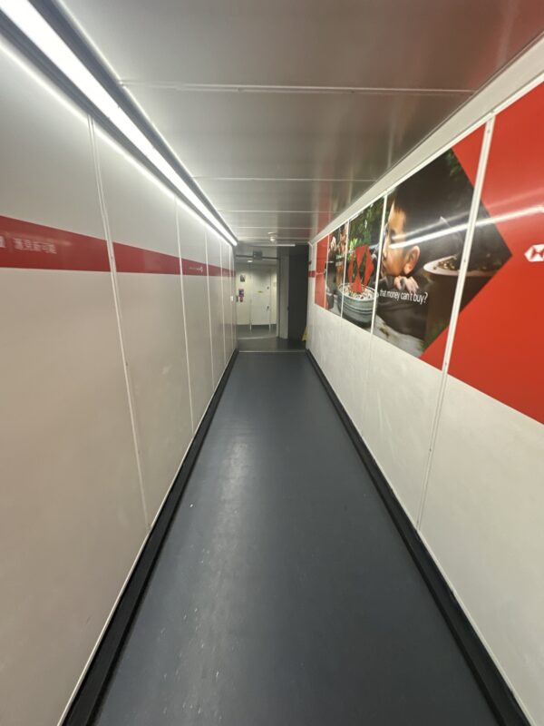 a long hallway with a red and white wall
