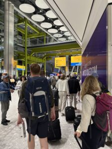 a group of people with luggage in a terminal