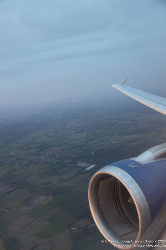 an airplane wing and a landscape