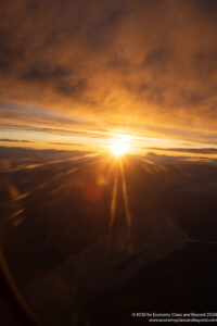 a sunset over clouds and water