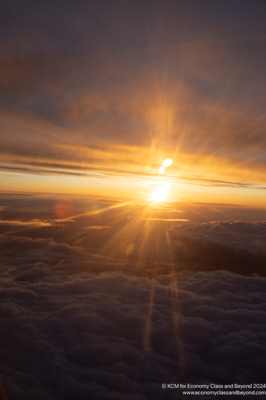 the sun setting over clouds