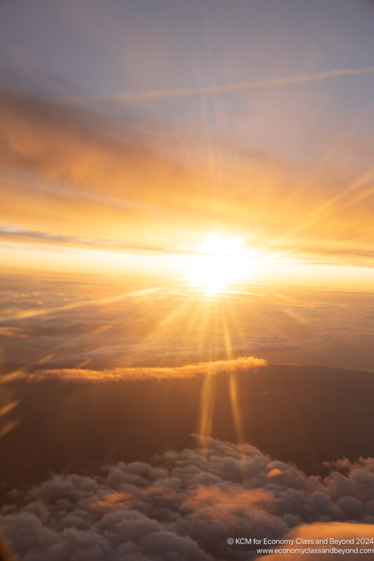 a sun setting over clouds