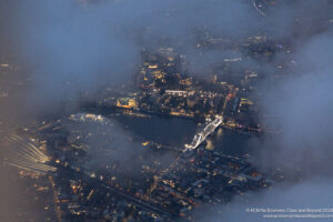 aerial view of a city with a bridge and a body of water