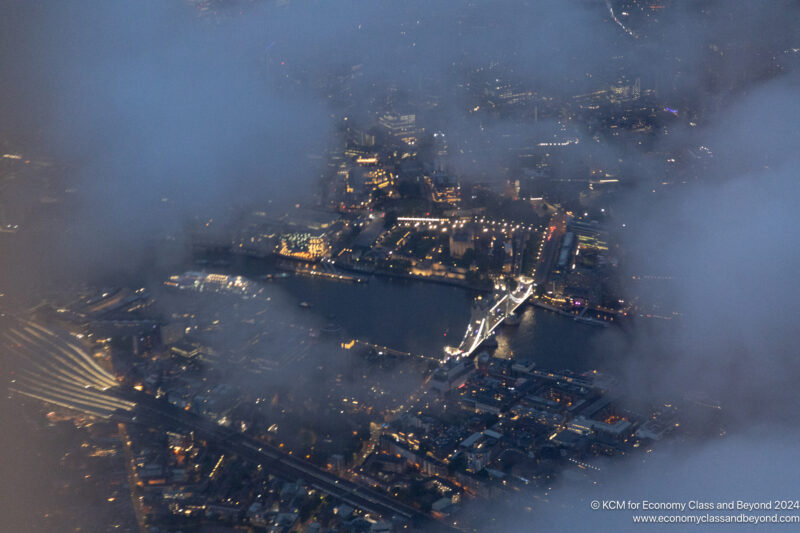 aerial view of a city with a bridge and a body of water