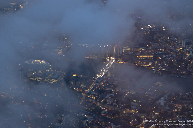 aerial view of a city with lights and fog