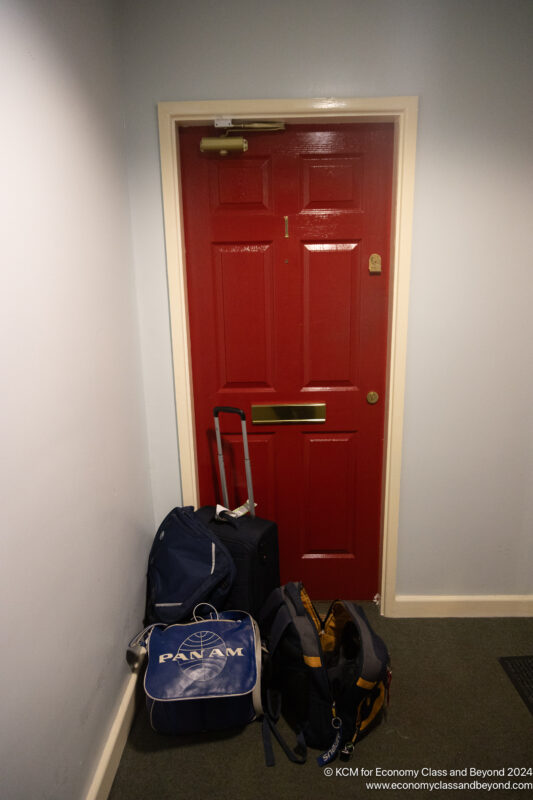 a red door with luggage on it