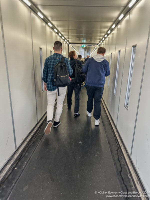 a group of people walking down a hallway