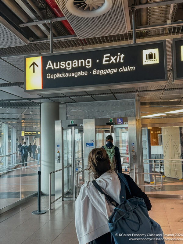 a woman standing in front of a sign