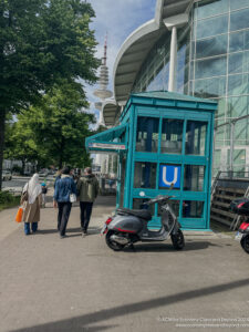 a group of people walking by a phone booth