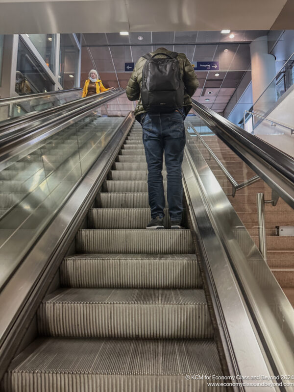 a man and woman on an escalator