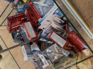 a group of boxes and model airplanes in a glass case