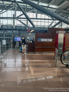 a man standing in a lobby of an airport