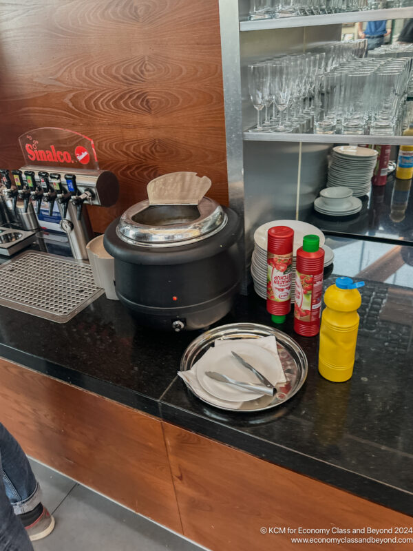 a counter with a machine and plates and utensils