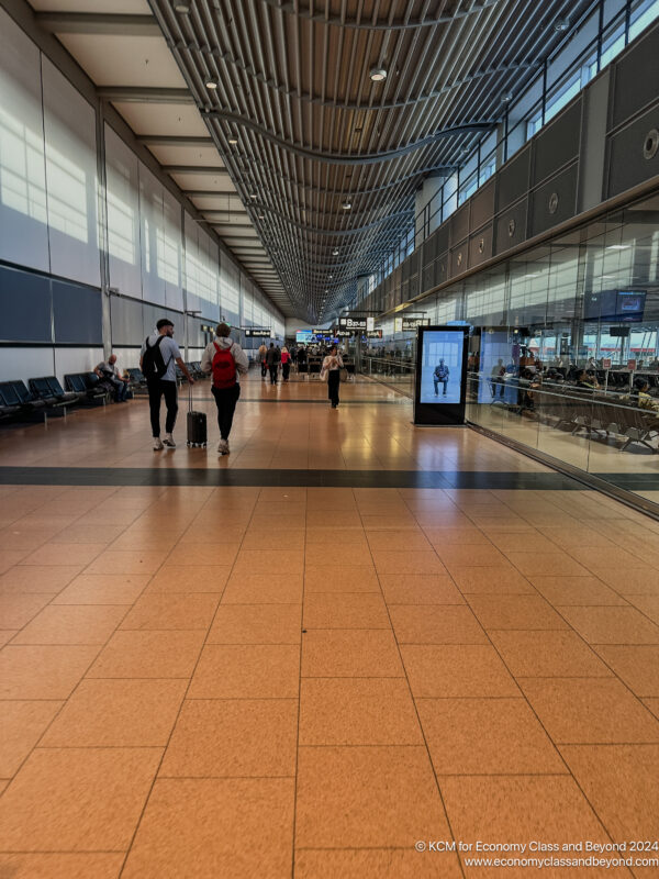 people walking in a large airport