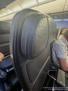 a black leather chair with a white shirt and a man sleeping