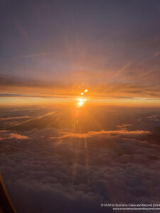 the sun setting over clouds