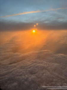 a sun setting over clouds
