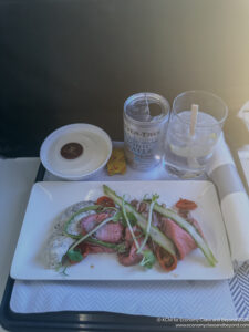 a plate of food and drinks on a tray