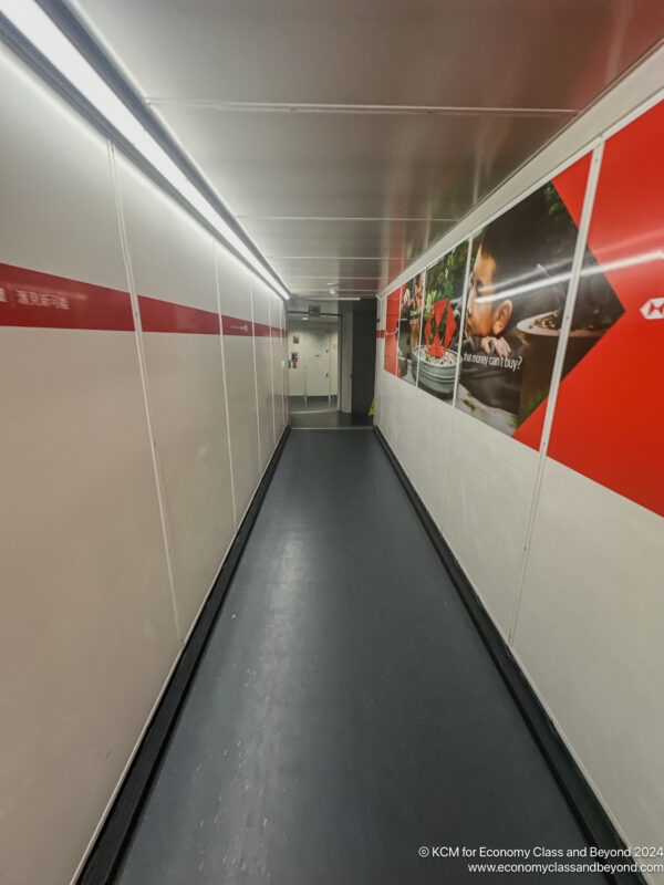 a long hallway with a sign on the wall