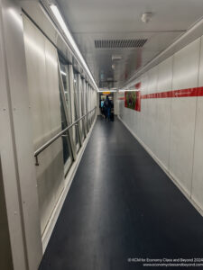 a long white hallway with people walking