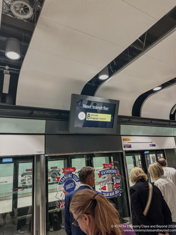 a group of people standing in a subway station