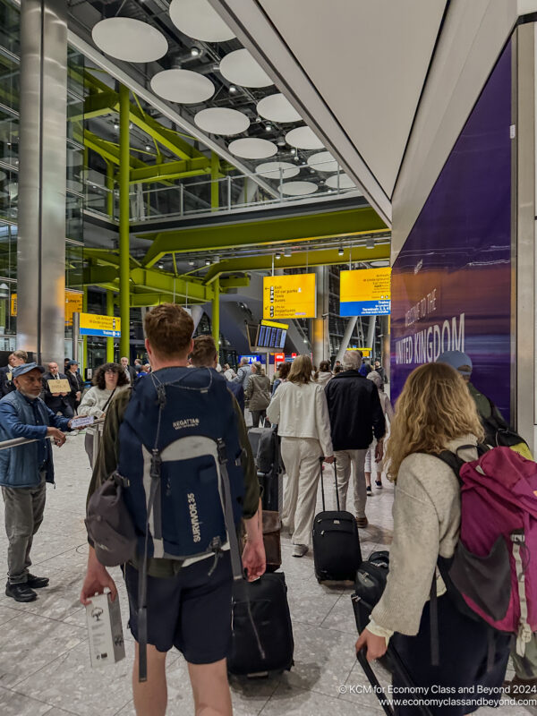 a group of people with luggage in a terminal