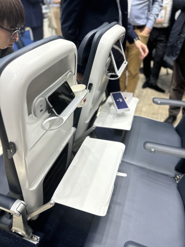 a seat with a phone and a cup on it