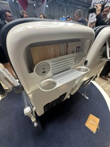 a white and black chair with a round object on the back