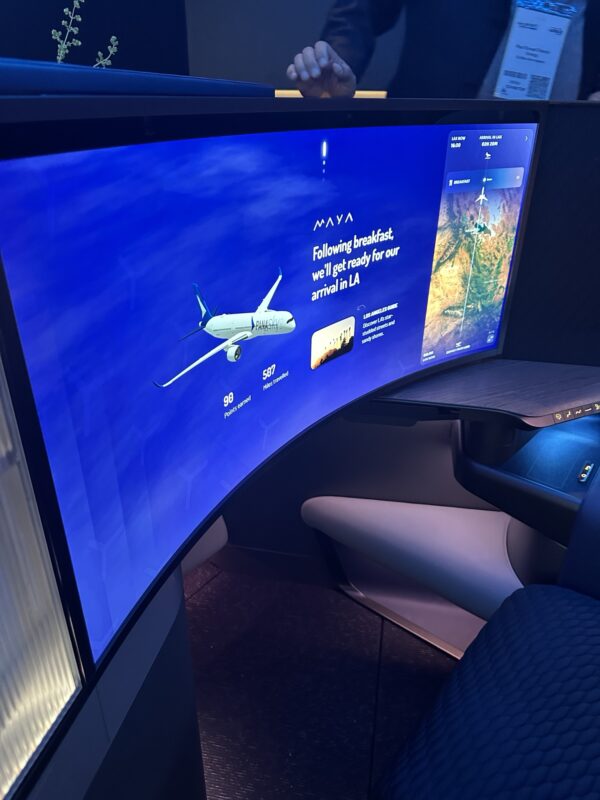 a curved screen with a plane on it