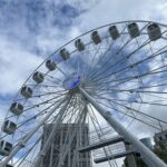 a ferris wheel with many cabins