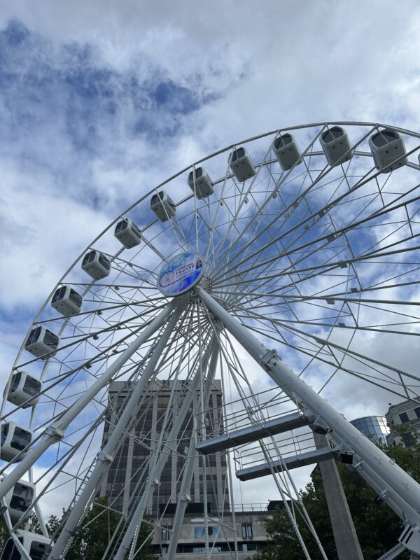 a ferris wheel with many cabins