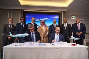 a group of men standing at a table with airplanes