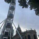 a ferris wheel in front of a building