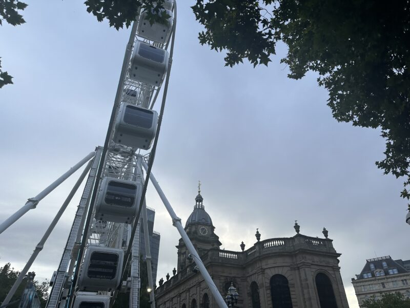 a ferris wheel in front of a building