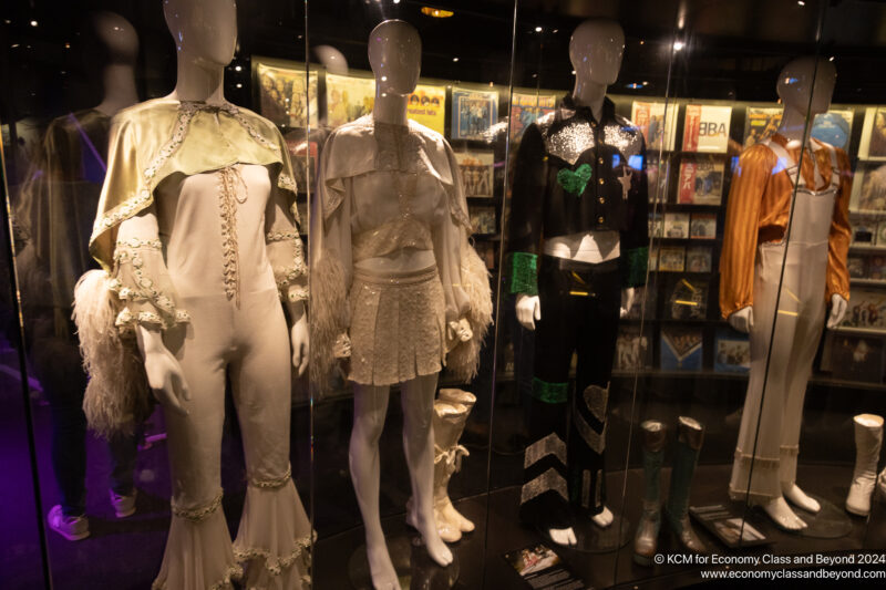 a group of mannequins in a room with glass walls