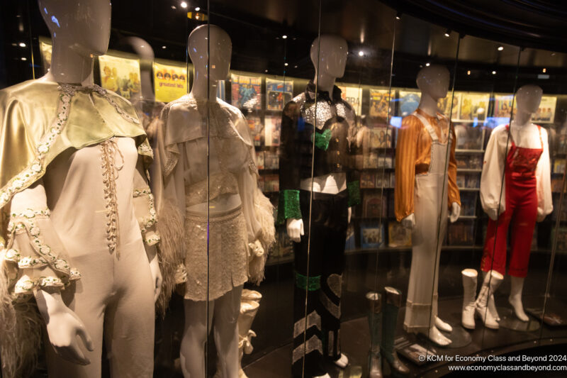 a group of mannequins in a glass case