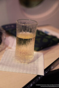 a glass of liquid on a napkin