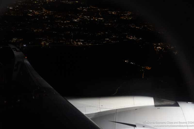 an airplane wing and wing of an airplane at night