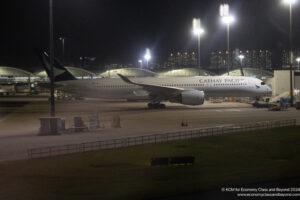 a large white airplane on a runway at night