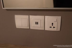 a wall with electrical outlets and switches