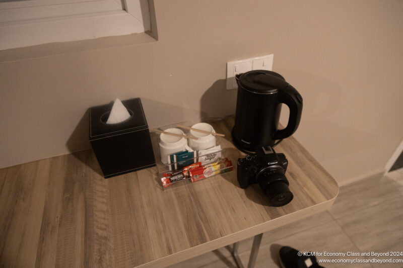 a camera and coffee pot on a table