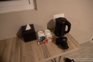 a camera and coffee pot on a table