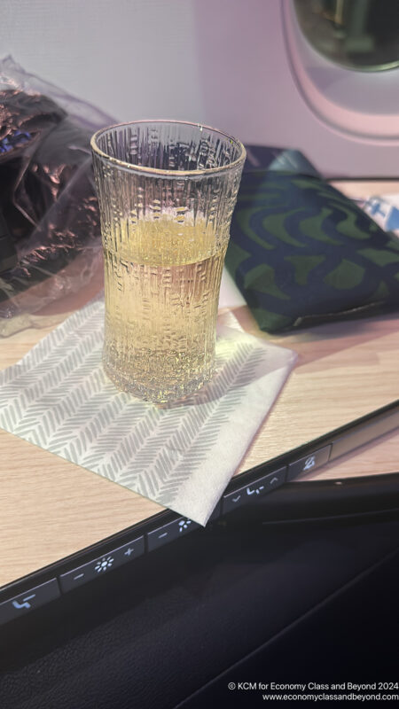 a glass of liquid on a napkin