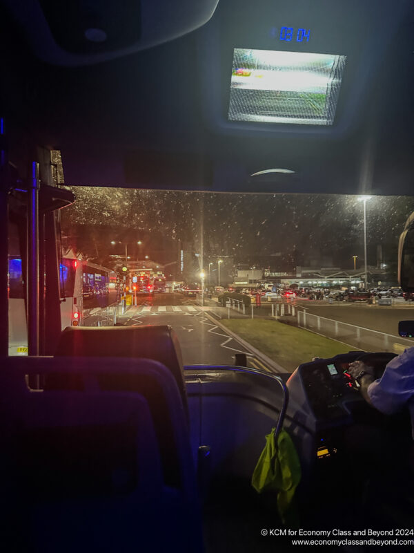 a view from inside of a bus at night