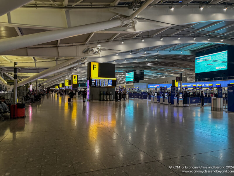 a large airport terminal with people walking