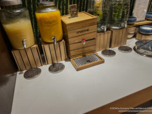 a group of drinks dispensers on a counter