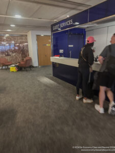 people standing at a reception desk